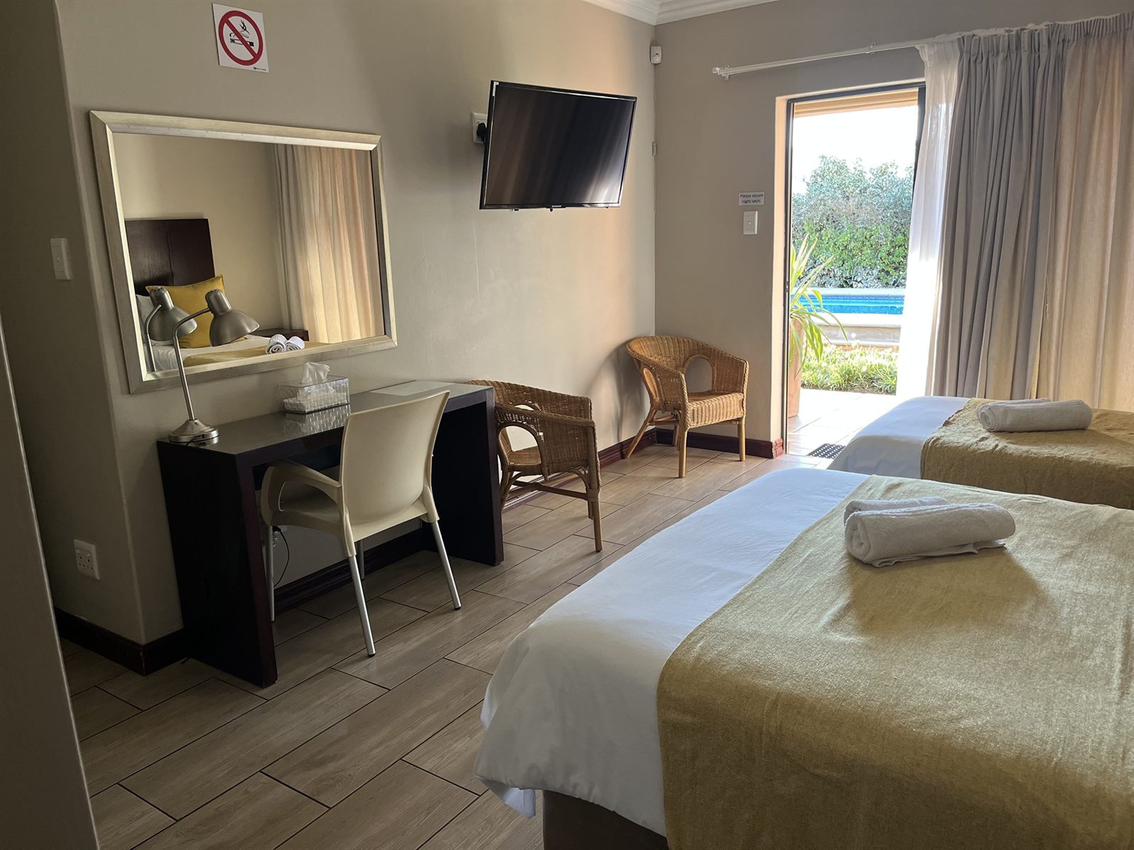 Standard Family Room desk, Smart TV and patio doors onto the pool at Cozy Corner Brandwag