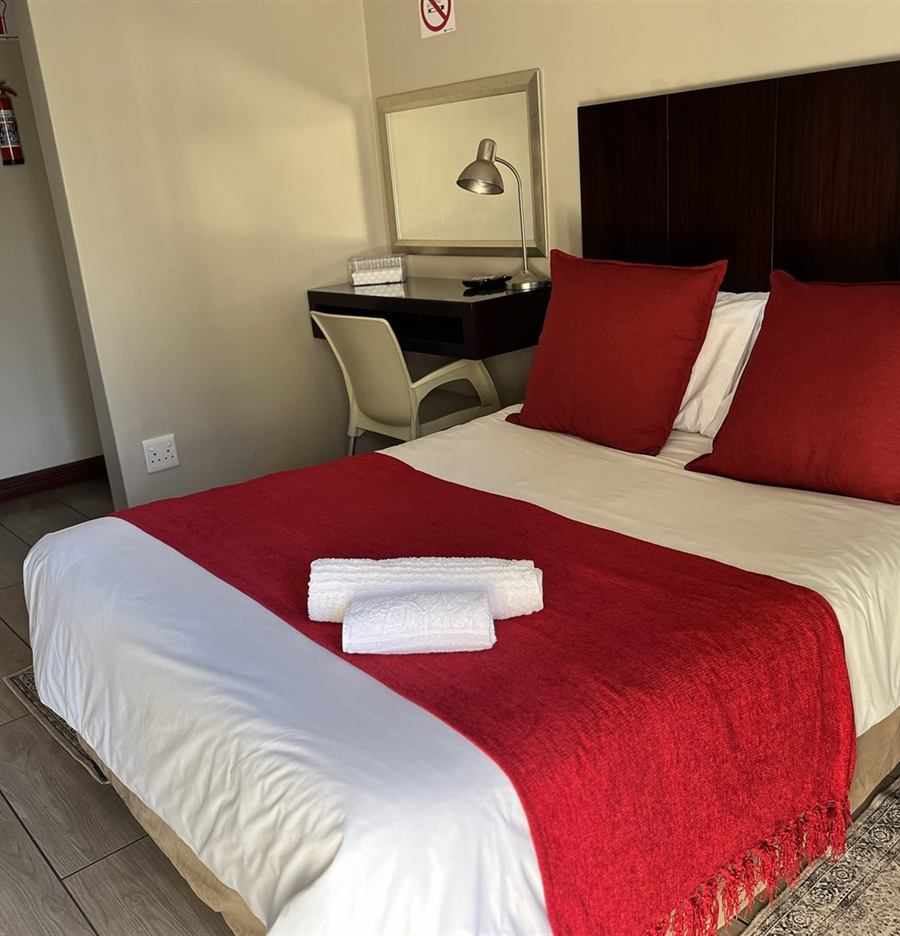 Freshly made bed with clean folded towels at Cozy Corner Brandwag